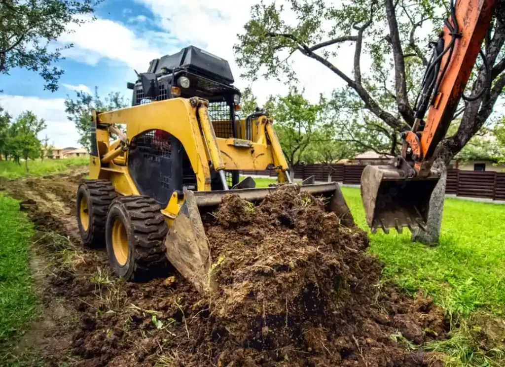 Mini excavator clearing land
